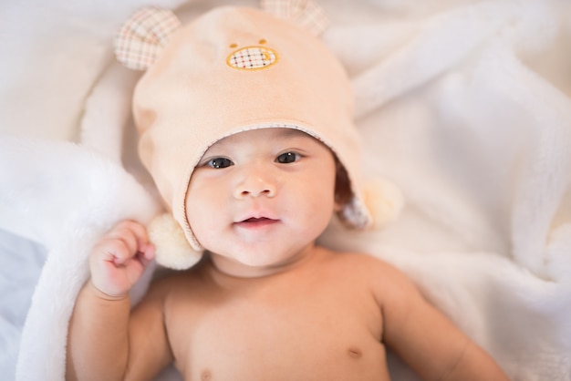 Portrait asia baby on white bed