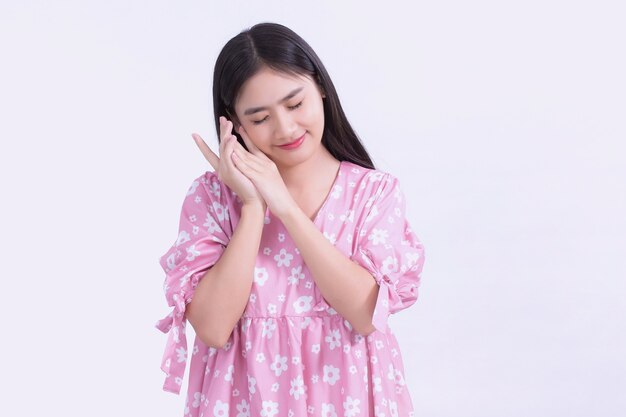 Portrait of asian beautiful woman in pink dress and black long hair her hands touch