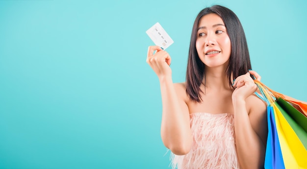 Portrait asian beautiful woman smiling holding shopping bags and credit card