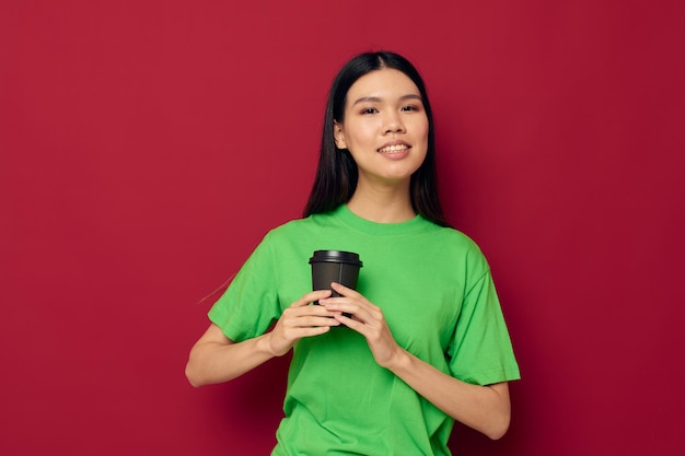 Portrait Asian beautiful young woman posing in a green tshirt disposable black glasses studio model unaltered