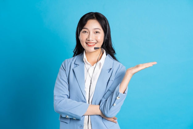 Portrait of asian business woman posing on blue background