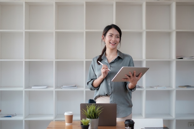 Portrait of Asian Business woman working with tablet in office