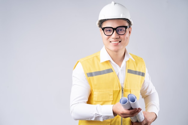 portrait of Asian engineer with smiling on gray