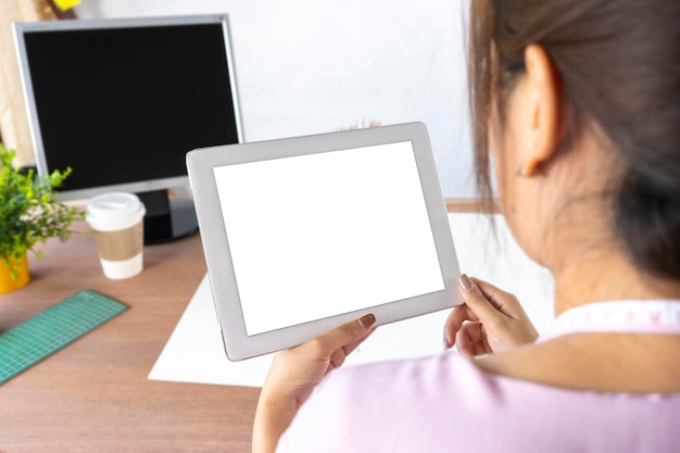 Portrait Asian female designers holding gadget in hands using wifi internet in modern office with interior Electronic wireless device concept