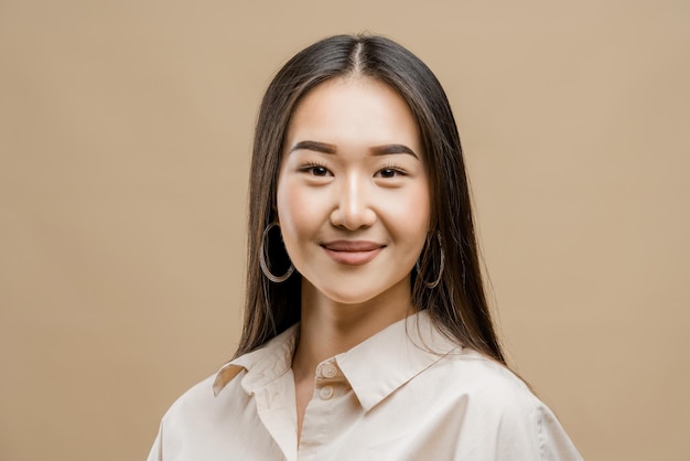 Portrait of a asian girl on a light brown background