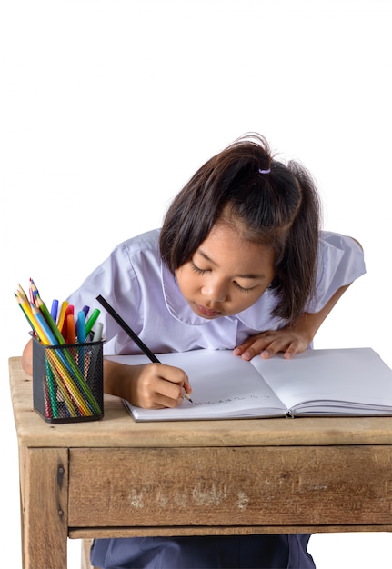 Portrait of asian girl in school uniform is drawing with color pencils isolated on white background