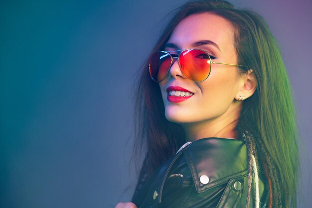 Portrait of asian girl in sunglasses and black leather jacket in smoky fog