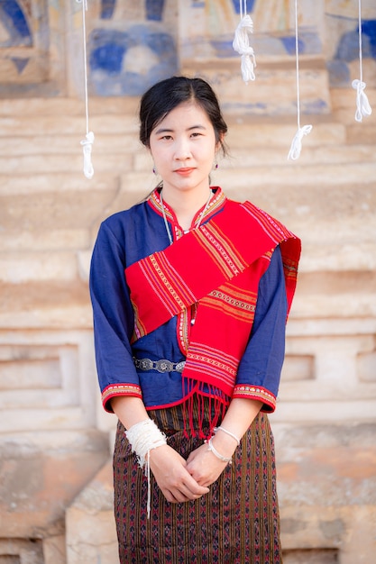 Portrait of asian girl with Thai local traditional dress famous in countryside of Thailand