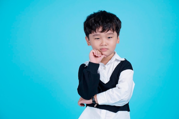 Portrait of Asian handsome little kid boy isolated on blue background