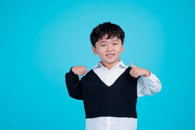 Portrait of Asian handsome little kid boy isolated on blue background