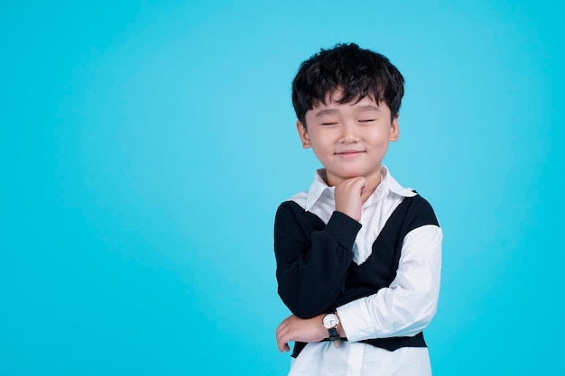 Portrait of Asian handsome little kid boy isolated on blue background