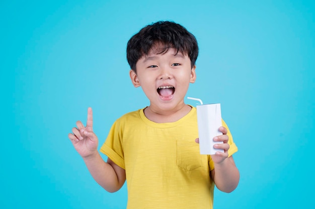 Portrait of Asian handsome little kid boy isolated on blue background