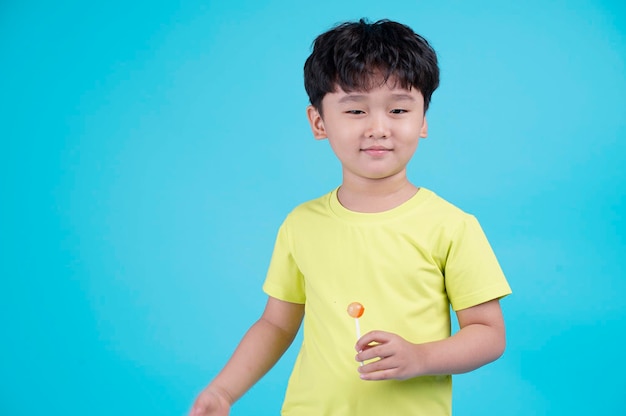 Portrait of Asian handsome little kid boy isolated on blue background