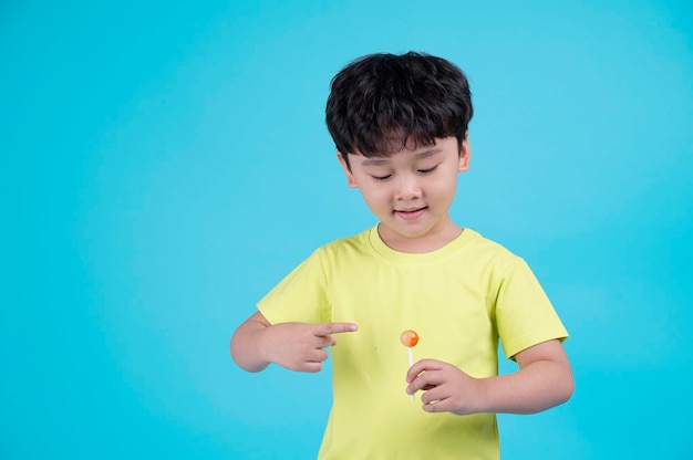 Portrait of Asian handsome little kid boy isolated on blue background