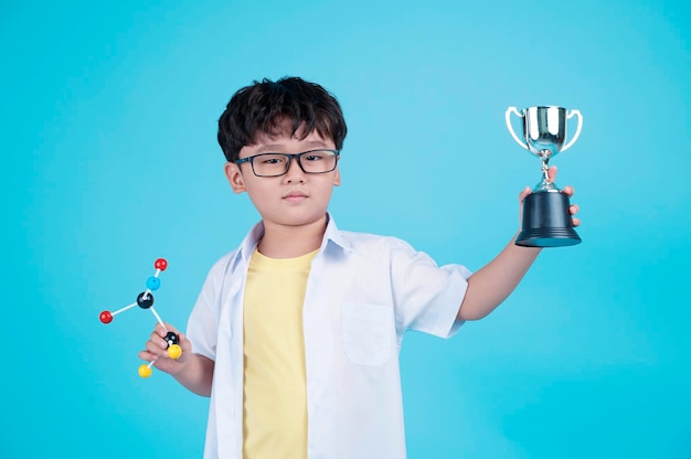 Portrait of Asian handsome little kid boy isolated on blue background