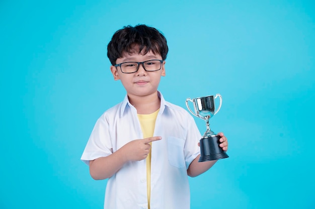 Portrait of Asian handsome little kid boy isolated on blue background