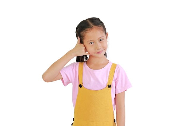 Portrait of Asian little girl kid making phone gesture isolated on white background. Call me back sign