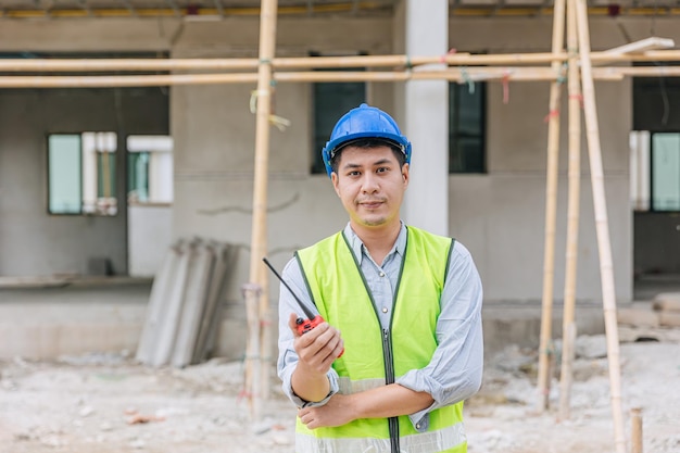 Portrait Asian male builder worker foreman engineer at construction site home building project