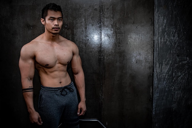 Portrait of asian man big muscle at the gymThailand peopleWorkout for good healthyBody weight trainingFitness at the gym concept