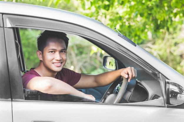 Portrait of asian man in a car