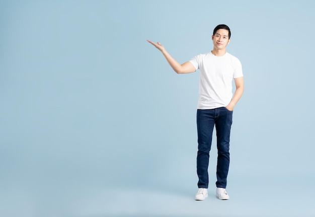 Portrait of asian man posing on blue background