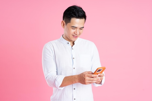 Portrait of asian man posing on pink background