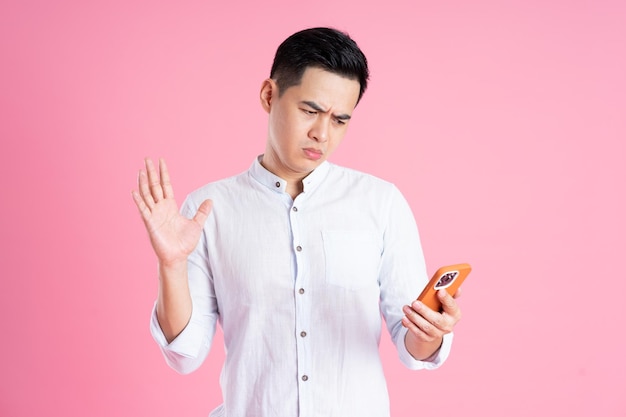 Portrait of asian man posing on pink background