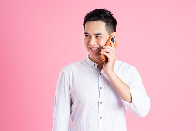 Portrait of asian man posing on pink background