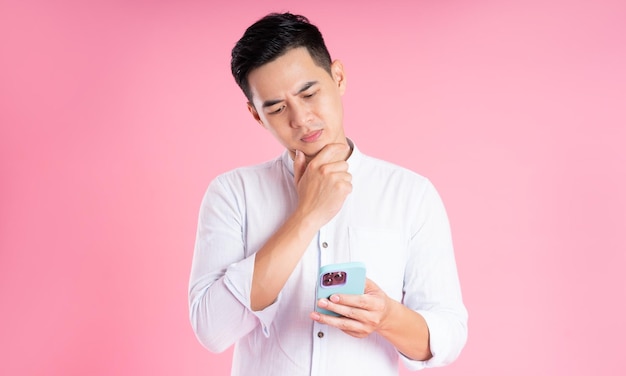 Portrait of asian man posing on pink background