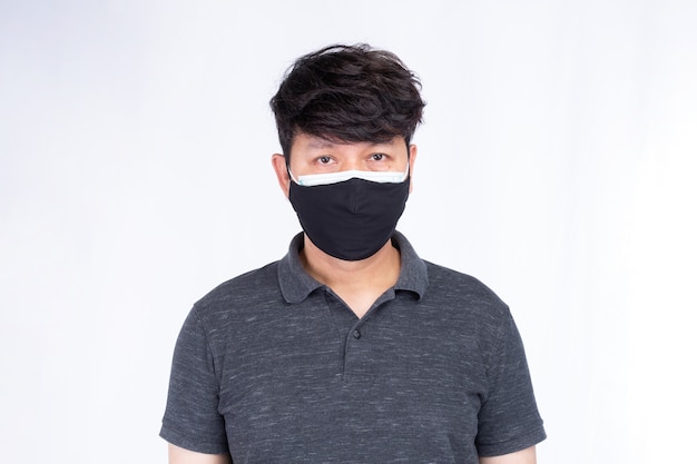 portrait of asian man wearing surgical face mask two layers two pieces to protect  covid19 concept