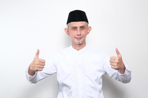 Portrait of Asian Moslem Man with doing positive gesture with hand, thumbs up, ok sign