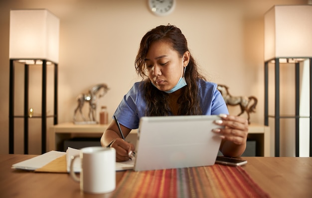 Portrait of Asian nurse at home