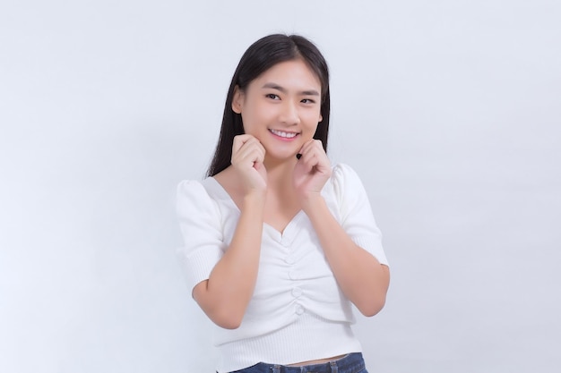 Portrait Asian pretty girl with long hair is smiling and touching her face on white background