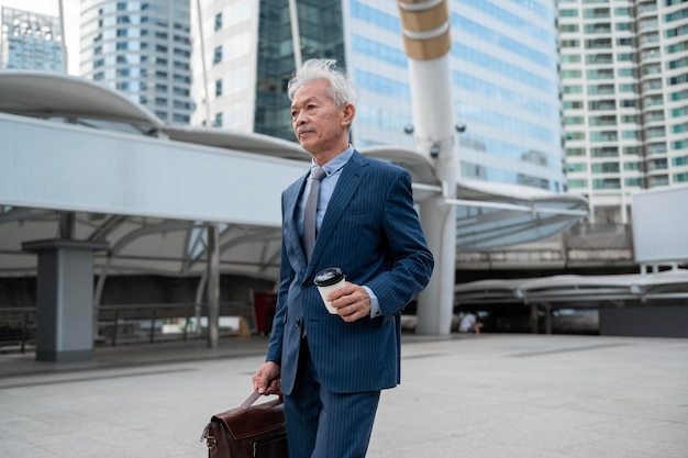 Portrait of Asian senior mature middle aged businessman in modern city