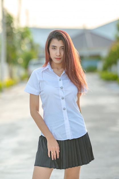 Portrait of asian or thai student university uniform beautiful girl relax and smile