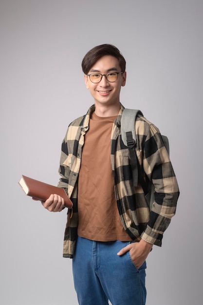 Portrait of an Asian university student over white background studio education conceptx9