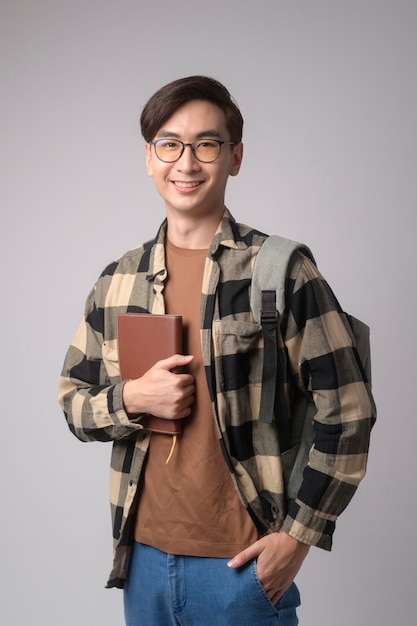 Portrait of an Asian university student over white background studio education conceptx9