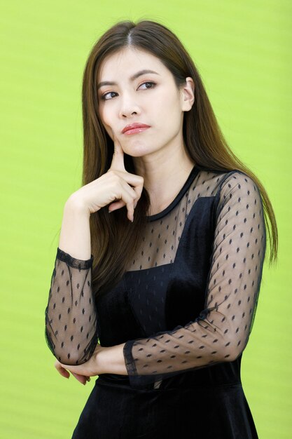 Portrait of Asian woman in black see through dress standking and pose with friendly positive smile face. Concept Beautiful and confident working woman.