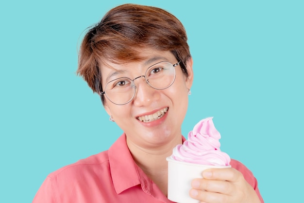 Portrait of an Asian woman Happy holding ice cream isolated on a color background