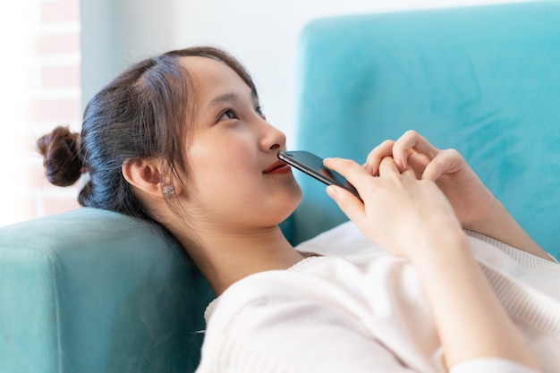 Portrait of asian woman at home, on sofa