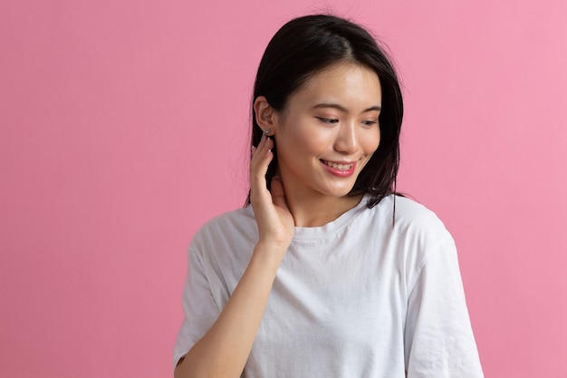 Portrait of asian woman on pink background