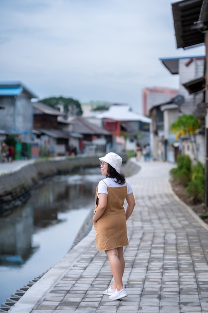 Portrait asian woman tourist Traveler walking and with travel at Mae Kha canal New Landmark It is a major tourist is Public places attraction Chiang Mai CityThailandtravel and leisure concept day