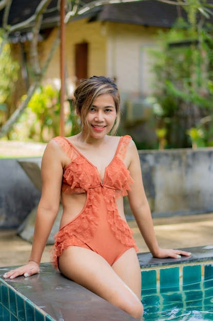 Portrait of Asian women wear swimsuits Background swimming pool