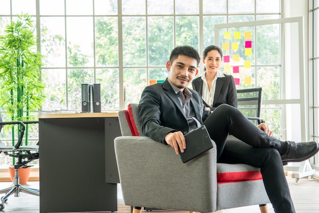 Portrait Asian young couple sit on sofa together, business concept