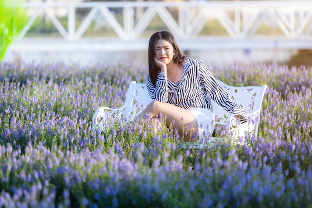 Portrait of asian Young woman happy traveler with black and white pattern dress enjoying in white blooming flower field in the nature garden of in Thailandtravel relax vacation