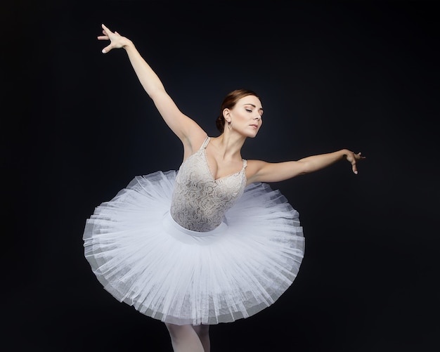 Portrait of an attractive ballerina on a black background