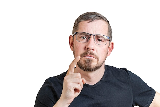 Portrait of an attractive bearded man of European appearance with a slight gray hair on an isolated white background He raised his index finger Expression of emotions of a man