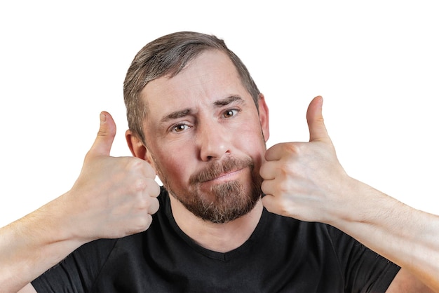 Portrait of an attractive bearded man of European appearance with a slight gray hair on an isolated white background He raised his thumb up Expression of emotions of a man