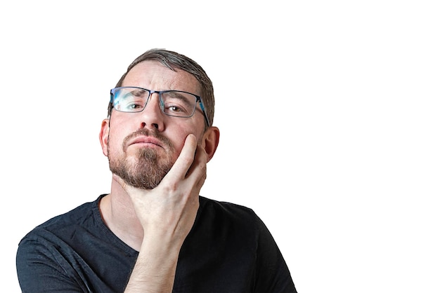 Portrait of an attractive bearded man of European appearance with a slight gray hair on an isolated white background Thoughtfully rubs his beard Expression of emotions of a man