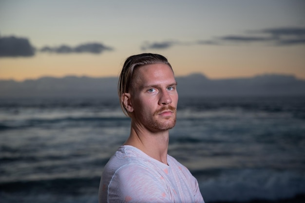 Portrait of an attractive caucasian boy at the beach during sunset